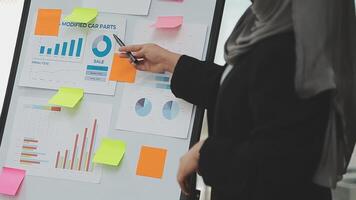 Financial analysts analyze business financial reports on a digital tablet planning investment project during a discussion at a meeting of corporate showing the results of their successful teamwork. video