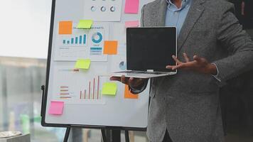 Financial analysts analyze business financial reports on a digital tablet planning investment project during a discussion at a meeting of corporate showing the results of their successful teamwork. video