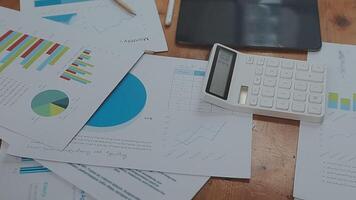 Financial analysts analyze business financial reports on a digital tablet planning investment project during a discussion at a meeting of corporate showing the results of their successful teamwork. video