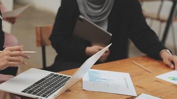 Financial analysts analyze business financial reports on a digital tablet planning investment project during a discussion at a meeting of corporate showing the results of their successful teamwork. video