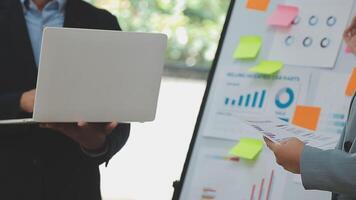 Financial analysts analyze business financial reports on a digital tablet planning investment project during a discussion at a meeting of corporate showing the results of their successful teamwork. video