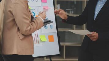 Financial analysts analyze business financial reports on a digital tablet planning investment project during a discussion at a meeting of corporate showing the results of their successful teamwork. video