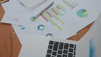 Financial analysts analyze business financial reports on a digital tablet planning investment project during a discussion at a meeting of corporate showing the results of their successful teamwork. video