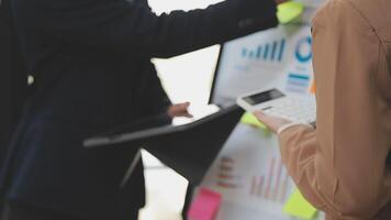 Financial analysts analyze business financial reports on a digital tablet planning investment project during a discussion at a meeting of corporate showing the results of their successful teamwork. video