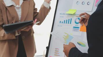 Financial analysts analyze business financial reports on a digital tablet planning investment project during a discussion at a meeting of corporate showing the results of their successful teamwork. video