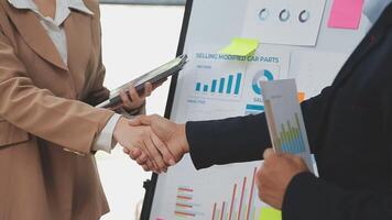 Financial analysts analyze business financial reports on a digital tablet planning investment project during a discussion at a meeting of corporate showing the results of their successful teamwork. video