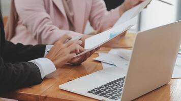 Financial analysts analyze business financial reports on a digital tablet planning investment project during a discussion at a meeting of corporate showing the results of their successful teamwork. video