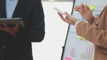 Financial analysts analyze business financial reports on a digital tablet planning investment project during a discussion at a meeting of corporate showing the results of their successful teamwork. video