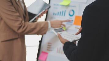 Financial analysts analyze business financial reports on a digital tablet planning investment project during a discussion at a meeting of corporate showing the results of their successful teamwork. video