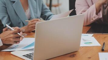 Financial analysts analyze business financial reports on a digital tablet planning investment project during a discussion at a meeting of corporate showing the results of their successful teamwork. video