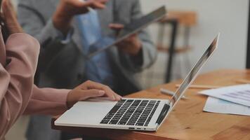 Financial analysts analyze business financial reports on a digital tablet planning investment project during a discussion at a meeting of corporate showing the results of their successful teamwork. video