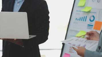 Financial analysts analyze business financial reports on a digital tablet planning investment project during a discussion at a meeting of corporate showing the results of their successful teamwork. video