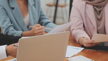 Financial analysts analyze business financial reports on a digital tablet planning investment project during a discussion at a meeting of corporate showing the results of their successful teamwork. video