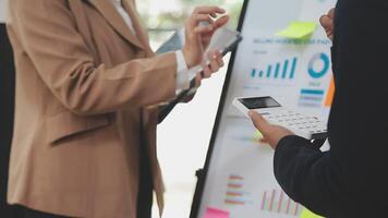 Financial analysts analyze business financial reports on a digital tablet planning investment project during a discussion at a meeting of corporate showing the results of their successful teamwork. video