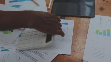Financial analysts analyze business financial reports on a digital tablet planning investment project during a discussion at a meeting of corporate showing the results of their successful teamwork. video