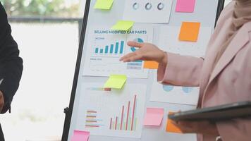 Financial analysts analyze business financial reports on a digital tablet planning investment project during a discussion at a meeting of corporate showing the results of their successful teamwork. video