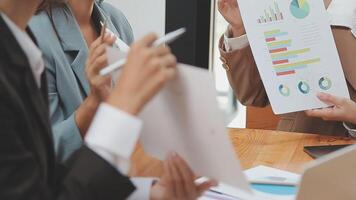 Financial analysts analyze business financial reports on a digital tablet planning investment project during a discussion at a meeting of corporate showing the results of their successful teamwork. video