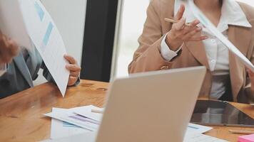 Financial analysts analyze business financial reports on a digital tablet planning investment project during a discussion at a meeting of corporate showing the results of their successful teamwork. video