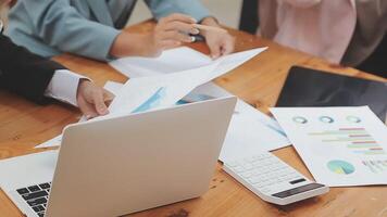 Financial analysts analyze business financial reports on a digital tablet planning investment project during a discussion at a meeting of corporate showing the results of their successful teamwork. video