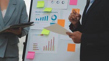 Financial analysts analyze business financial reports on a digital tablet planning investment project during a discussion at a meeting of corporate showing the results of their successful teamwork. video