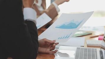 Financial analysts analyze business financial reports on a digital tablet planning investment project during a discussion at a meeting of corporate showing the results of their successful teamwork. video
