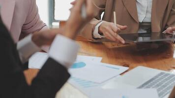 Financial analysts analyze business financial reports on a digital tablet planning investment project during a discussion at a meeting of corporate showing the results of their successful teamwork. video