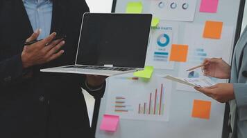 Financial analysts analyze business financial reports on a digital tablet planning investment project during a discussion at a meeting of corporate showing the results of their successful teamwork. video