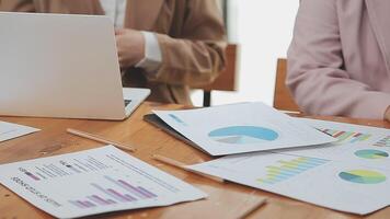 Financial analysts analyze business financial reports on a digital tablet planning investment project during a discussion at a meeting of corporate showing the results of their successful teamwork. video