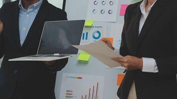 Financial analysts analyze business financial reports on a digital tablet planning investment project during a discussion at a meeting of corporate showing the results of their successful teamwork. video
