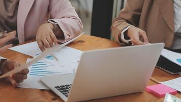 Financial analysts analyze business financial reports on a digital tablet planning investment project during a discussion at a meeting of corporate showing the results of their successful teamwork. video