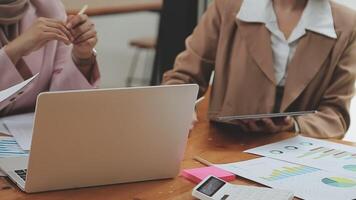 Financial analysts analyze business financial reports on a digital tablet planning investment project during a discussion at a meeting of corporate showing the results of their successful teamwork. video