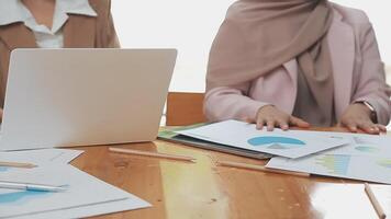 Financial analysts analyze business financial reports on a digital tablet planning investment project during a discussion at a meeting of corporate showing the results of their successful teamwork. video