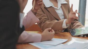 Financial analysts analyze business financial reports on a digital tablet planning investment project during a discussion at a meeting of corporate showing the results of their successful teamwork. video