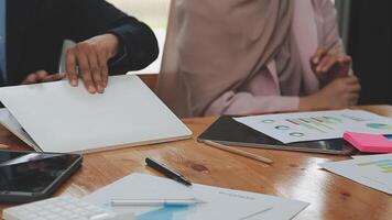 Financial analysts analyze business financial reports on a digital tablet planning investment project during a discussion at a meeting of corporate showing the results of their successful teamwork. video