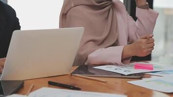 Financial analysts analyze business financial reports on a digital tablet planning investment project during a discussion at a meeting of corporate showing the results of their successful teamwork. video