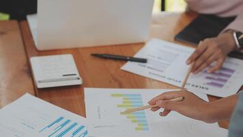 Financial analysts analyze business financial reports on a digital tablet planning investment project during a discussion at a meeting of corporate showing the results of their successful teamwork. video