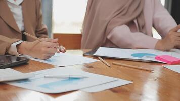 Financial analysts analyze business financial reports on a digital tablet planning investment project during a discussion at a meeting of corporate showing the results of their successful teamwork. video