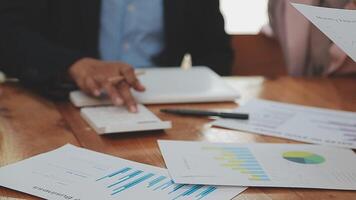Financial analysts analyze business financial reports on a digital tablet planning investment project during a discussion at a meeting of corporate showing the results of their successful teamwork. video