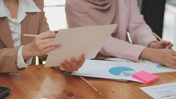 Financial analysts analyze business financial reports on a digital tablet planning investment project during a discussion at a meeting of corporate showing the results of their successful teamwork. video