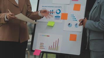 Financial analysts analyze business financial reports on a digital tablet planning investment project during a discussion at a meeting of corporate showing the results of their successful teamwork. video