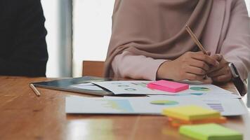 Financial analysts analyze business financial reports on a digital tablet planning investment project during a discussion at a meeting of corporate showing the results of their successful teamwork. video