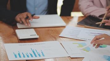 Financial analysts analyze business financial reports on a digital tablet planning investment project during a discussion at a meeting of corporate showing the results of their successful teamwork. video