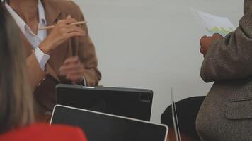 Financial analysts analyze business financial reports on a digital tablet planning investment project during a discussion at a meeting of corporate showing the results of their successful teamwork. video