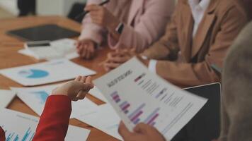 Financial analysts analyze business financial reports on a digital tablet planning investment project during a discussion at a meeting of corporate showing the results of their successful teamwork. video