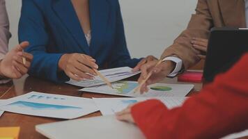Financial analysts analyze business financial reports on a digital tablet planning investment project during a discussion at a meeting of corporate showing the results of their successful teamwork. video