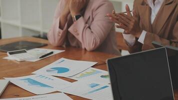 Financial analysts analyze business financial reports on a digital tablet planning investment project during a discussion at a meeting of corporate showing the results of their successful teamwork. video