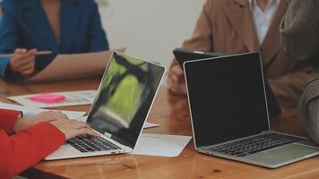Financial analysts analyze business financial reports on a digital tablet planning investment project during a discussion at a meeting of corporate showing the results of their successful teamwork. video