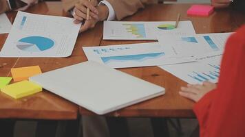 Financial analysts analyze business financial reports on a digital tablet planning investment project during a discussion at a meeting of corporate showing the results of their successful teamwork. video