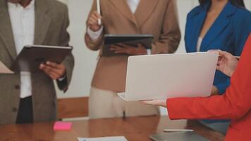 Financial analysts analyze business financial reports on a digital tablet planning investment project during a discussion at a meeting of corporate showing the results of their successful teamwork. video