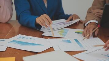 Financial analysts analyze business financial reports on a digital tablet planning investment project during a discussion at a meeting of corporate showing the results of their successful teamwork. video